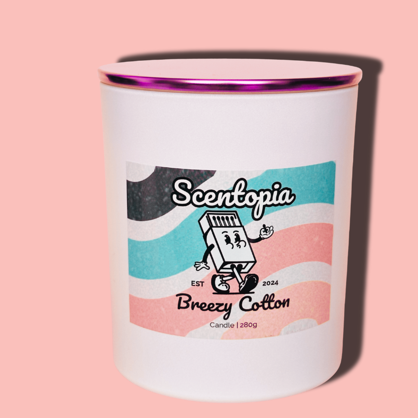 Candle in a white container with a colorful label on a pink background