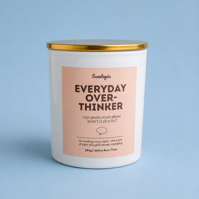 Candle with 'Everyday Over-Thinker' label on a blue background