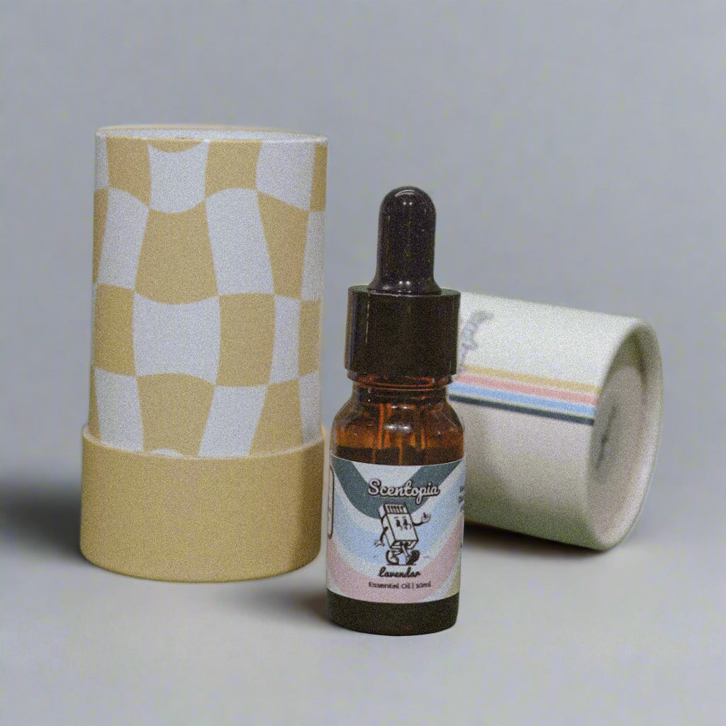 A bottle of lavender essential oil with a dropper, next to a beige and white checkered container on a green background.
