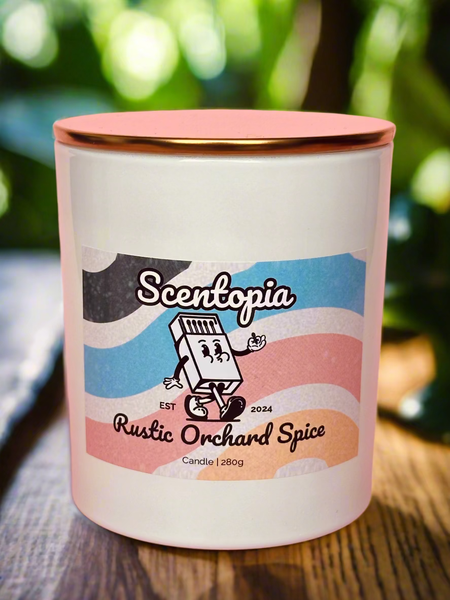 Scentopia Rustic Orchard Spice candle on a wooden surface with a blurred green background