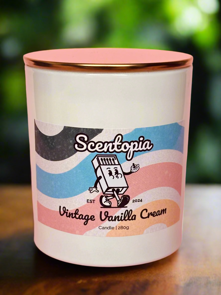 Scentopia vintage vanilla cream candle on a wooden surface with a blurred green background