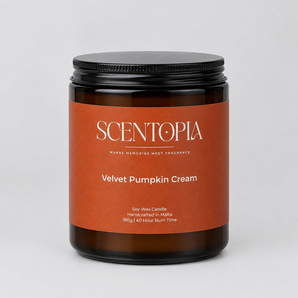 A jar of Scentopia Velvet Pumpkin Cream handcrafted scent wax candle, sitting on a wooden surface against a plain beige wall.