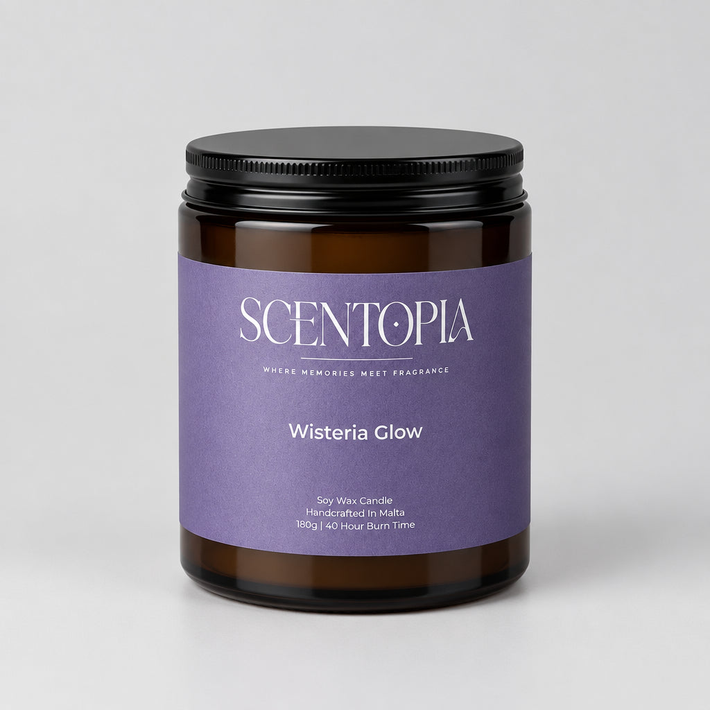 A Scentopia Wisteria Glow scented wax melt jar with a dark purple label and black lid, sitting on a wooden surface against a plain beige wall.